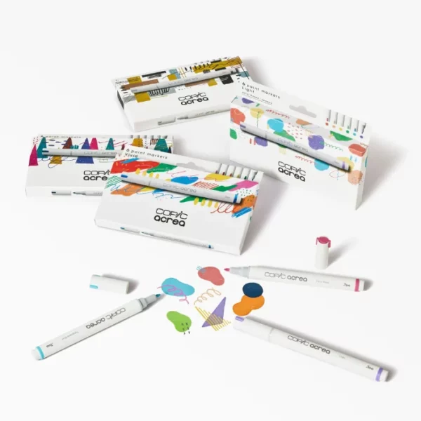 There are 4 Copic Acrea Paint Marker Set shown in the frame. They are scattered randomly within the frame, with loose markers around them. On a white background.