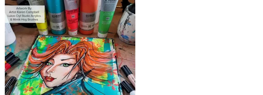 in the centre of the image is a painting of a woman with red hair in a very pop art fashion in vibrant colours and almost cartoonish way. behind the painting are various tubes of lukas cryl studio 125ml tubes and brushes. next to it are paint pens scattered around.