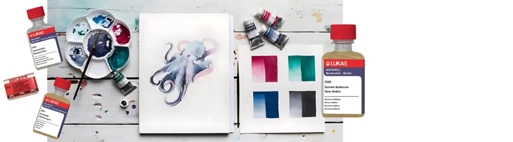 the center of the image is a table with watercolour paper on it with a painting of an octopus on it. to the left of it is a palette with paint in and a paintbrush resting on it. to the right are tubes of paint sitting on top of a colour swatch. on the left are three mediums scattered on the image and on the right is one medium standing straight half on the image.