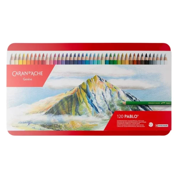 A single Set of 120 Caran D'Ache Pablo Coloured Pencils is shown in the center of the frame. It is the front of the tin. The tin is red and has an image of a mountain printed on it with a line of pencils along the top of teh tin. The logo is printed on the tin. On a white background.