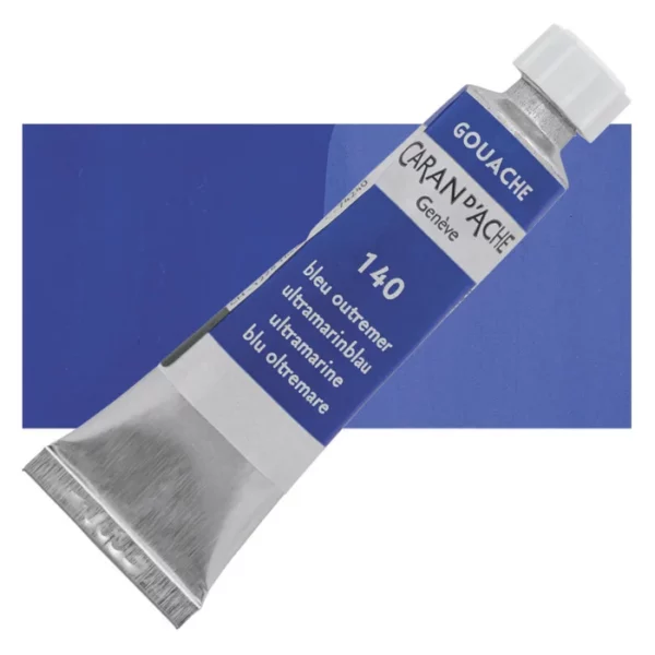 A single Ultramarine Caran D'Ache Studio Gouache Tube is shown diagonally across the center of the frame, overlapping a rectangular colour swatch in the background, which denotes the colour of the paint. The tube is silver and has a label around the body of the tube, that is printed in the colour of the paint. The Caran D'Ache logo, Paint Colour and details are printed on the label. The tube has a white plastic screw on cap. On a white background.