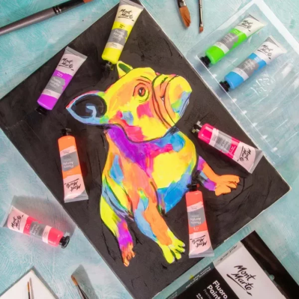 A multicoloured dog was painted using the Fluoro Mont Marte Premium Acrylic Paint Set. The dog was painted on a black bakground and there are numerous tubes laying on top of the canvas, around the dog.