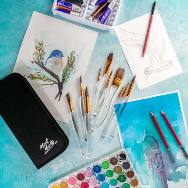 A promotional image for Mont Marte Acrylic Handle Watercolour Brush Set. The brushes are laying on a piece of watercolour paper within the frame. There is a painting of a bird on the paper. The brushes have clear acrylic handles. There is a part of a paint palette at the bottom of the frame. On a blue background.