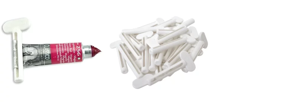 the left hand image is of a tube of oil paint with a paint saver key wrapped around the base of it. the right hand image is of a pile of paint saver keys all bunched together. both are on a white background