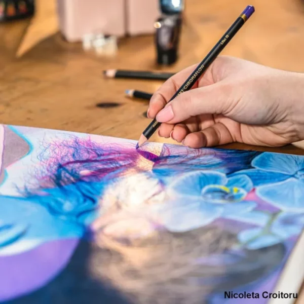 A close up of a person drawing a picture using the Set of 100 Derwent Chromaflow Pencils. The picture is in blues and purples.