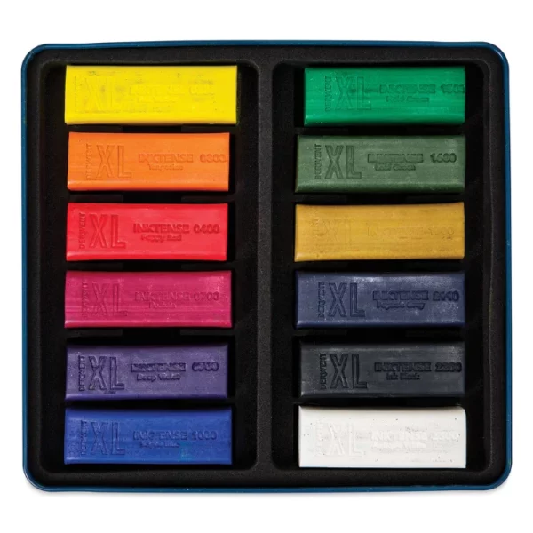 The inside tray of a Set of 12 Derwent Inktense XL Blocks is shown horizontally in the center of the frame. The block sticks are lined up next to each other. Each stick is a different colour. On a white background.