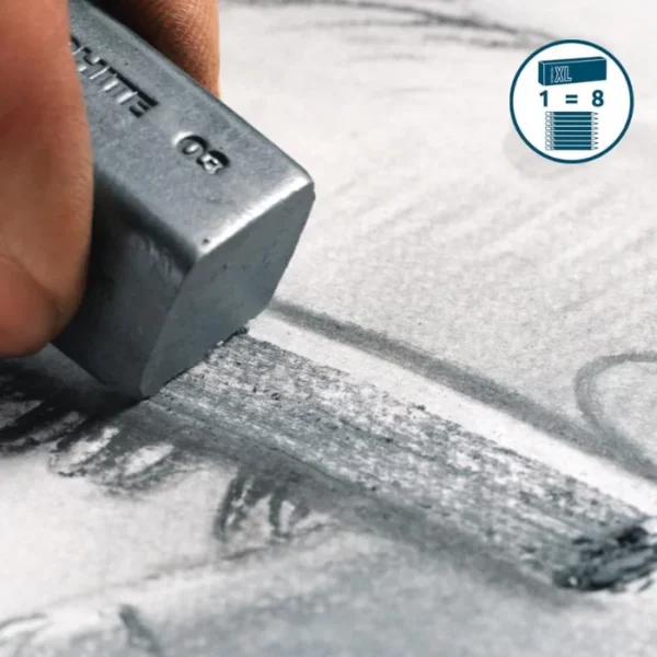 A persons hand is seen coming in from the left hand side of the page, They are holding an XL piece of graphite from the Set of 6 Derwent Graphite XL Blocks and drawing a thick line on a piece of paper. The image is cut off by the frame.