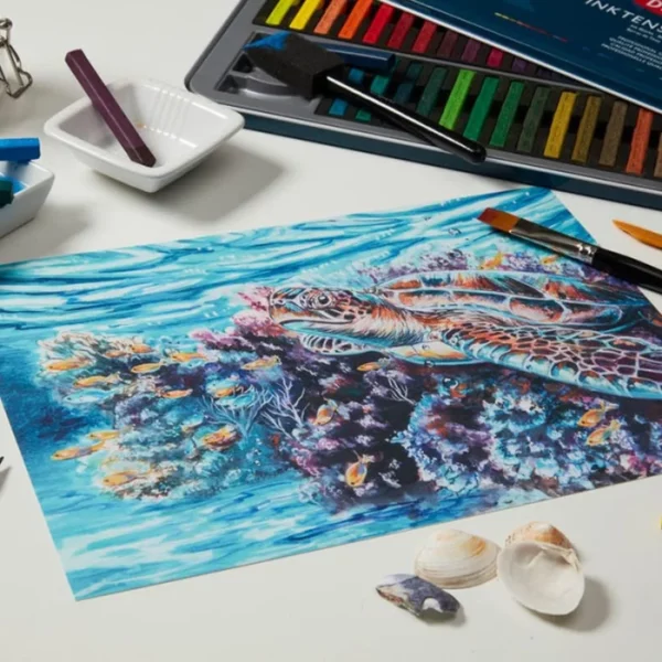 A picture of a turtle underwater has been drawn using the Set of 72 Derwent Inktense Blocks. There is a set in the background, but it is cut off by the frame.